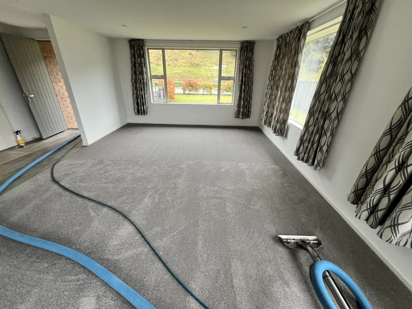 Carpet cleaning equipment in use on a carpet at a local property